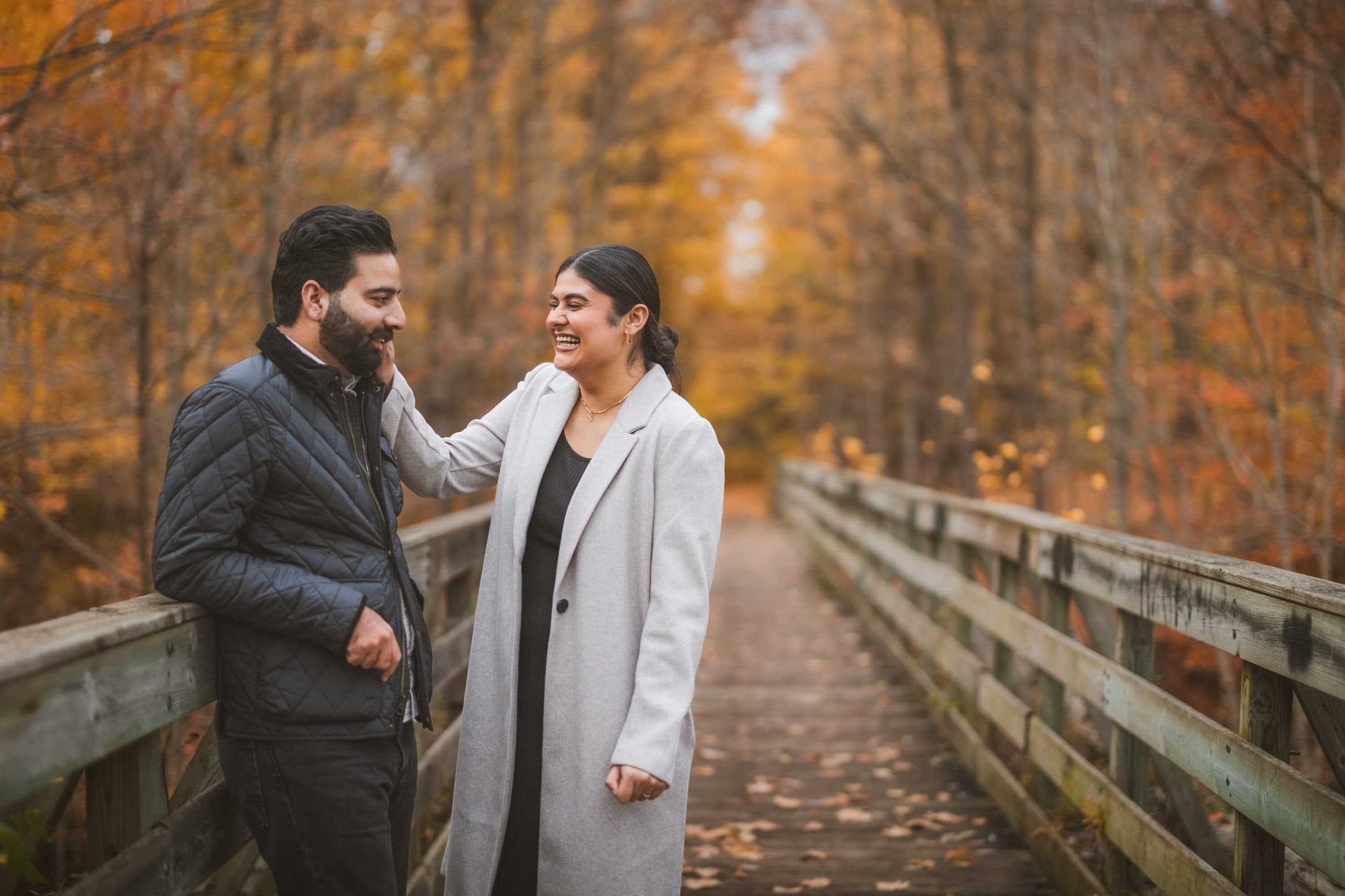 A couple seated together in a golden autumn field
